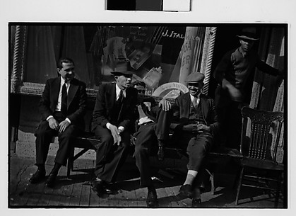 [Men Seated on Bench Outside Tobacconist Shop, New York City]