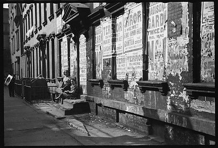 [View Down Street in Hell's Kitchen with Children on Stoop and Torn Circus Posters, New York City]