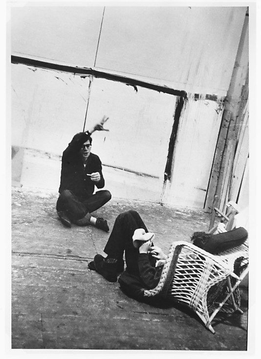 [Allen Ginsberg and Gregory Corso Seated on Floor in Conversation, During Filming of 