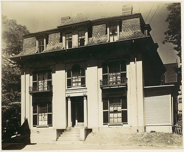 [Victorian Architecture: House with Fluted Columns and Mansard Roof]