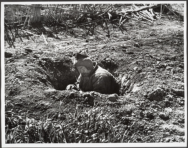His own garden provides this man with an air raid shelter, Hankow
