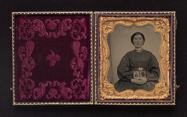 [Woman Holding Cased Portraits of Civil War Soldiers]