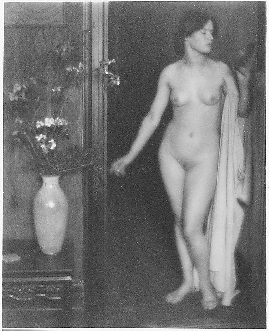 [Female Nude Standing in Doorway with Small Mirror in Hand]