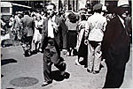 [Pedestrians, New York City: Man and Manhole in Foreground]