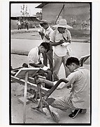 Visitors take notes on a peasant invention at National Farm Implements Exhibit, Peking