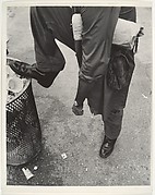 [Street Scene: Man Resting Foot on Lip of Trashcan, New York City]
