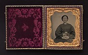 [Woman Holding Cased Portraits of Civil War Soldiers]
