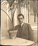 [Walker Evans Seated at Café Table with Potted Palm, Juan-les-Pins, France]
