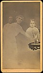 [Three Spirits with Photograph on Table]