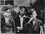 11:00 A.M. Monday, May 9th, 1910. Newsies at Skeeter's Branch, Jefferson near Franklin. They were all smoking. Location: St. Louis, Missouri.