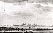 Distant Town Seen across Water and Fields