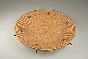 Fully feathered three-rod coiled plate-form basket, Pomo artist (Lake County, California), Willow shoot foundation, sedge root weft, feathers (red-winged blackbird, western meadowlark, mallard, California valley quail topknots), clamshell disk beads, abalone pendants, and cotton string, Pomo (Lake County, California)