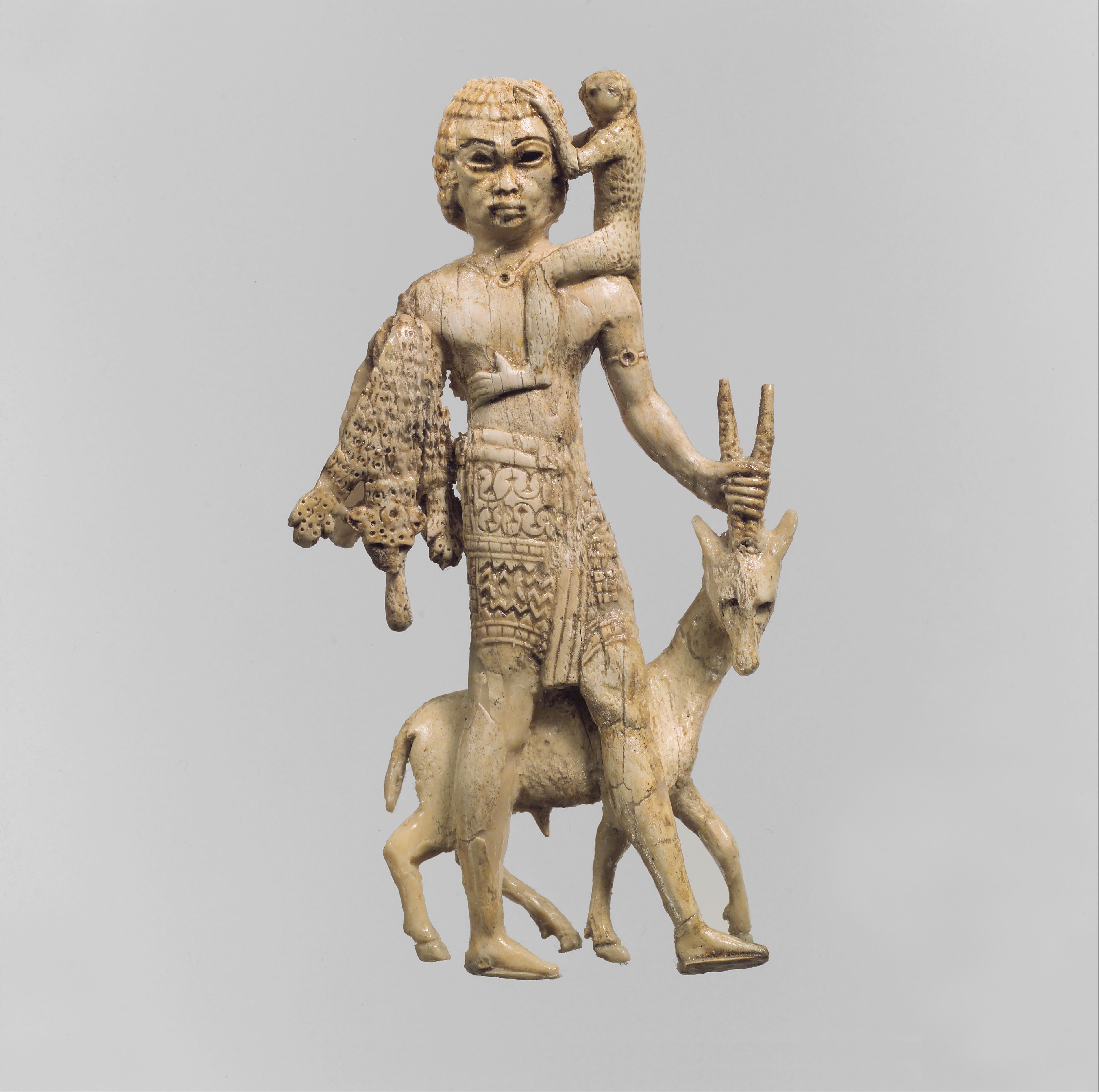 Figure of a man with an oryx, a monkey, and a leopard skin, Assyrian, Neo-Assyrian