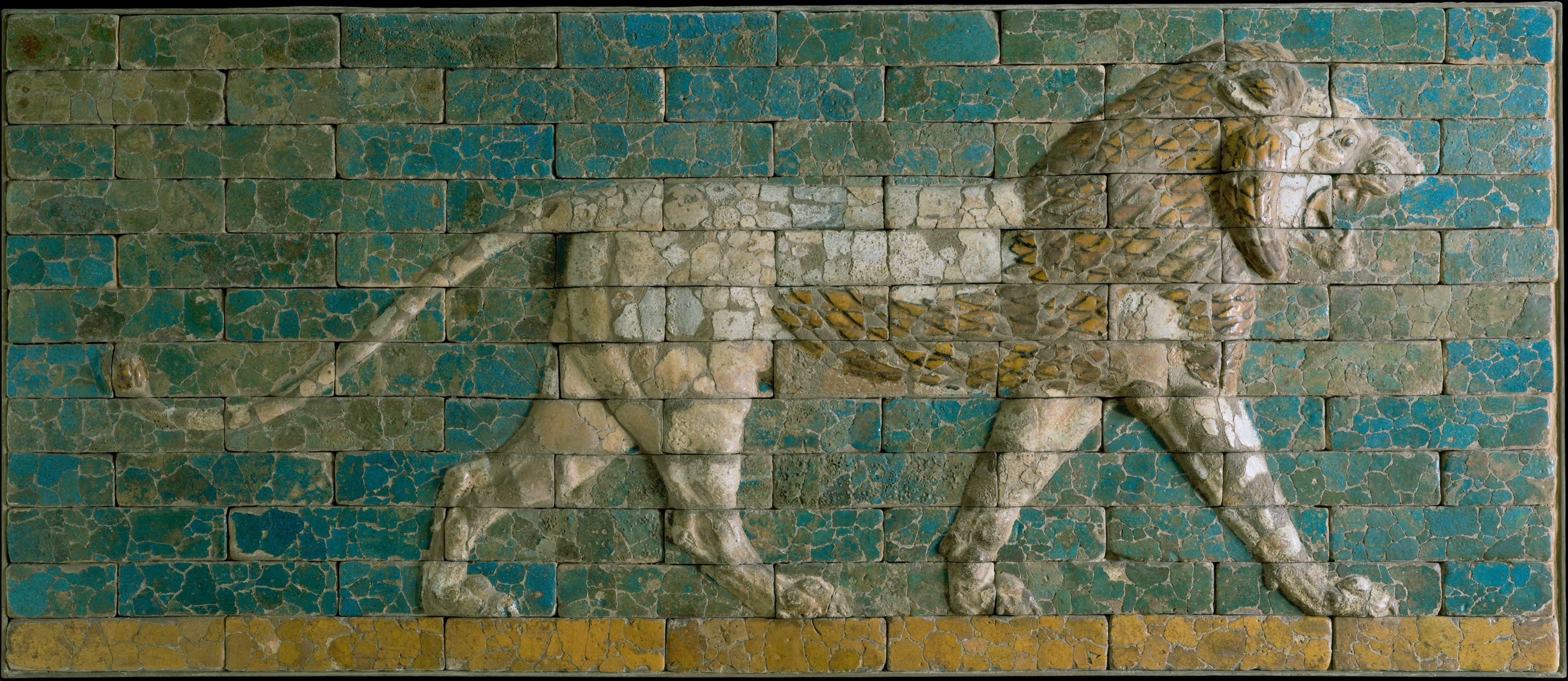 Glazed ceramic brick lion walking with its mouth open and teeth bared, from an excavated site in the ancient city of Babylon.