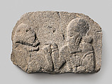 Relief: man holding up a cup to a woman, Basalt, Hittite