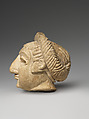 Female head with elaborate hairstyle, Limestone