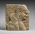 Relief: head and shoulders of a beardless man, possibly a eunuch, Gypsum alabaster, Assyrian