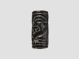 Cylinder seal and modern impression: man grasping an antelope, bull's head over ingot, Black-grey steatite, Cypriot