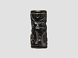 Cylinder seal and modern impression: man grasping an antelope, bull's head over ingot, Black-grey steatite, Cypriot