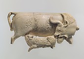 Openwork furniture plaque showing a cow suckling a calf, Ivory, Assyrian