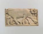 Furniture plaque carved in relief with a stag grazing among plants, Ivory, Assyrian