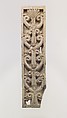 Furniture plaque carved in relief with volutes and a palmette, Ivory, Assyrian