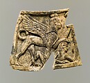Plaque carved in relief with sphinx trampling figure, Ivory, Assyrian