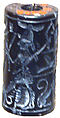 Cylinder seal and modern impression: hunter spearing a lion before deity with staff, Black hematite
