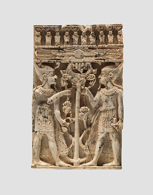Furniture plaque carved in high relief with two Egyptianizing figures flanking a volute tree