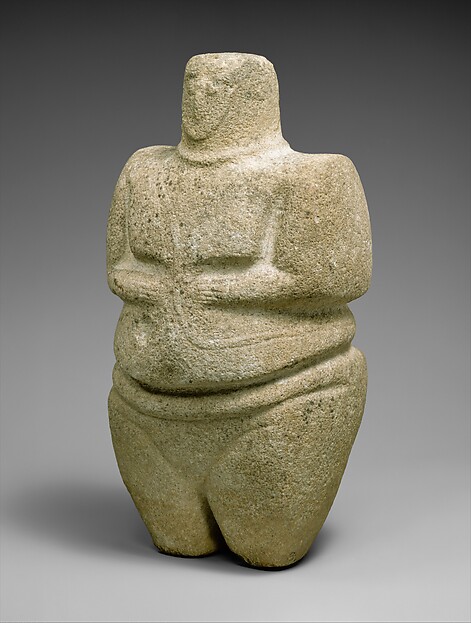Standing female figure wearing a strap and a necklace H. 10 5/8 × W. 5 1/2 × D. 4 5/16 in. (27 × 13.9 × 10.9 cm)