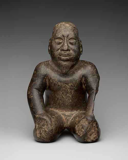 Kneeling bearded figure