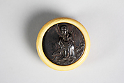 Netsuke of Shakyamuni Buddha, Ivory with bronze disk, Japan