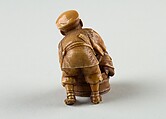 Netsuke of Man Forcing Monkey into a Basket, Ivory, Japan