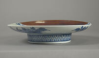 Dish with Cherry Blossoms and Textile Curtains, Porcelain with celadon glaze, partial brown glaze, and underglaze blue decoration (Hizen ware, Nabeshima type) , Japan