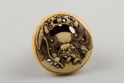 Netsuke Carved with Shishi; reverse with Lotus Leaf, Attributed to Rensai, Ivory, Japan