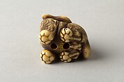 Netsuke of Seated Tiger with a Curled-up Tail Across its Back, Ivory, horn, Japan