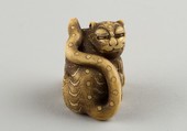 Netsuke of Seated Tiger with a Curled-up Tail Across its Back, Ivory, horn, Japan