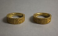 Pair of Bracelets, Engraved and chased sheet gold, metal core, Indonesia (Bali or Lombok)