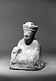 Miniature figure of a seated man, Earthenware with trace of green glaze, China