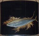 Case (Inrō) with Design of Flying Cuckoo in Flight above Pines (obverse); Bonito (Fish) on Bamboo Leaves (reverse), Toyōsai (1772–1845), Black lacquer with sprinkled gold and silver makie and mother-of-pearl
Ojime: bead with openwork design of waves; silver
Netsuke: fish laid on bamboo branch; stained ivory, Japan
