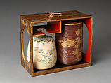 Picnic set with decoration of chrysanthemum and autumn grasses, Sprinkled gold and silver maki-e on red lacquer cabinet; sprinkled gold and black lacquer on red lacquer boxes; Kyoto-ware sake bottle (glazed stoneware with enamels), Japan