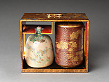 Picnic set with decoration of chrysanthemum and autumn grasses, Sprinkled gold and silver maki-e on red lacquer cabinet; sprinkled gold and black lacquer on red lacquer boxes; Kyoto-ware sake bottle (glazed stoneware with enamels), Japan