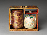 Picnic set with decoration of chrysanthemum and autumn grasses, Sprinkled gold and silver maki-e on red lacquer cabinet; sprinkled gold and black lacquer on red lacquer boxes; Kyoto-ware sake bottle (glazed stoneware with enamels), Japan