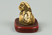 Netsuke of Qilin Sitting on a Nest, Ivory, red lacquer, Japan