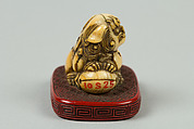 Netsuke of Qilin Sitting on a Nest, Ivory, red lacquer, Japan