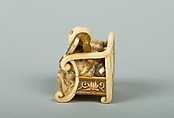 Netsuke of Hotei Seated in an Armchair, Ivory ornamented with lacquer, Japan