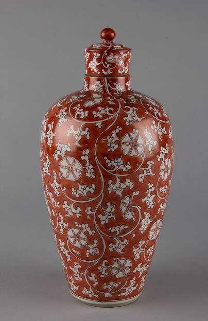 Covered bottle with floral scrolls (one of a pair)