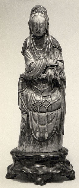 Seated Figure of Guanyin on Rock Base with Carved Armrest