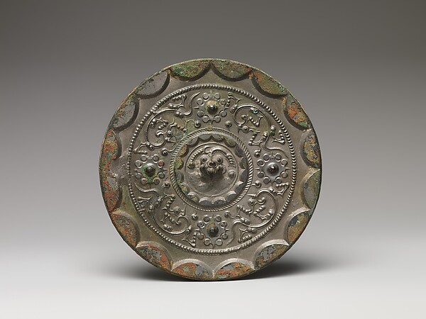 Mirror with dragons and knob-and-swirl design