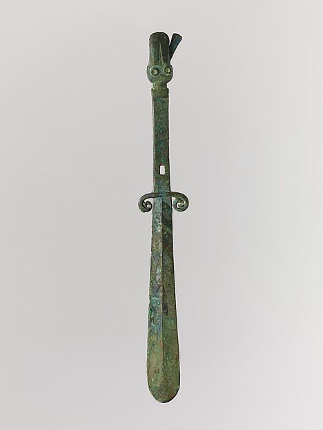 Implement with Curved Blade